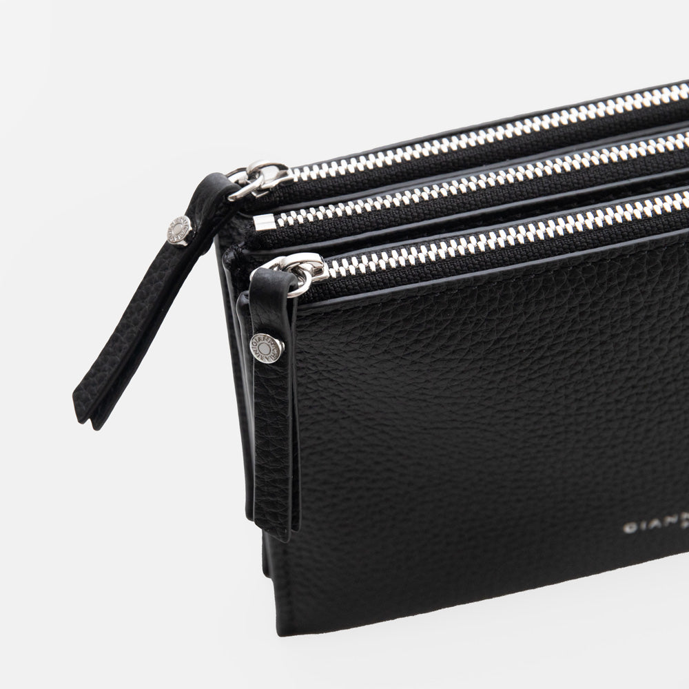 black leather envelope handbag on a light grey background