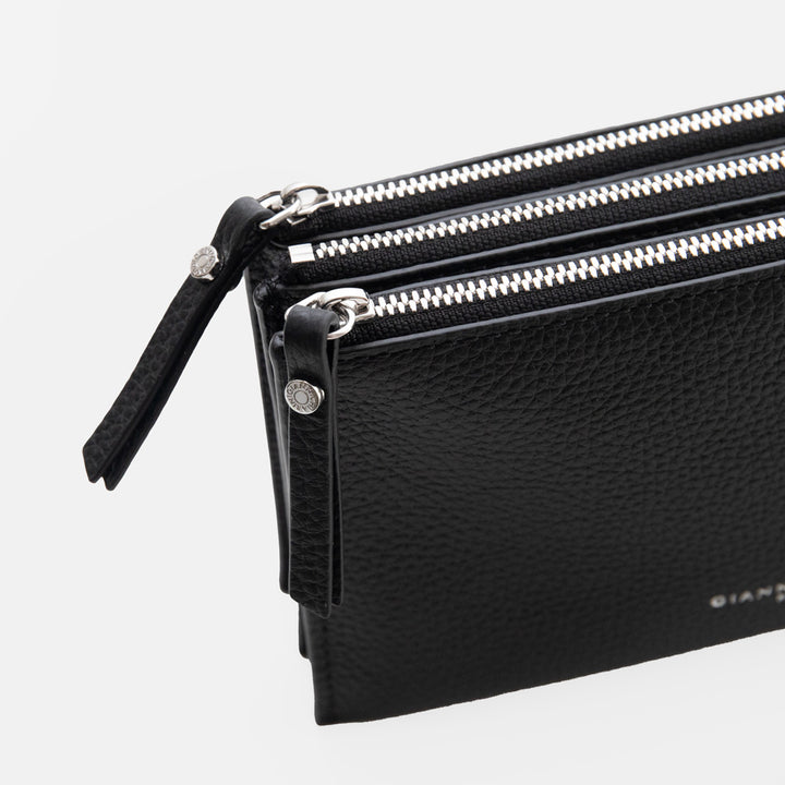 black leather envelope handbag on a light grey background