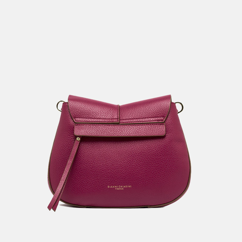 pink leather crossbody saddle bag with light brown webbing strap