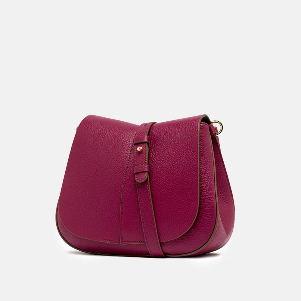 pink leather crossbody saddle bag with light brown webbing strap