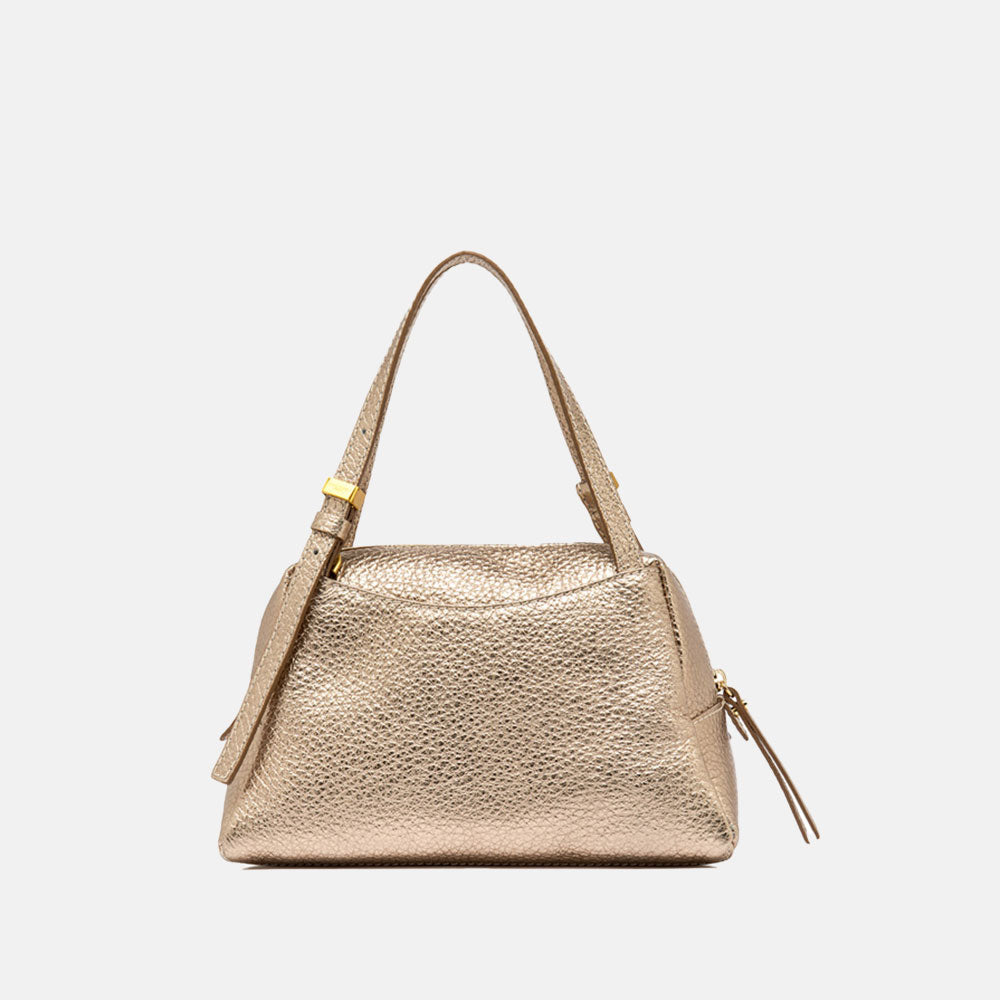 Gold handbag with matching strap on a light beige background