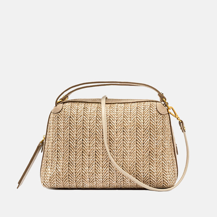 Woven straw handbag with a strap on a light grey background