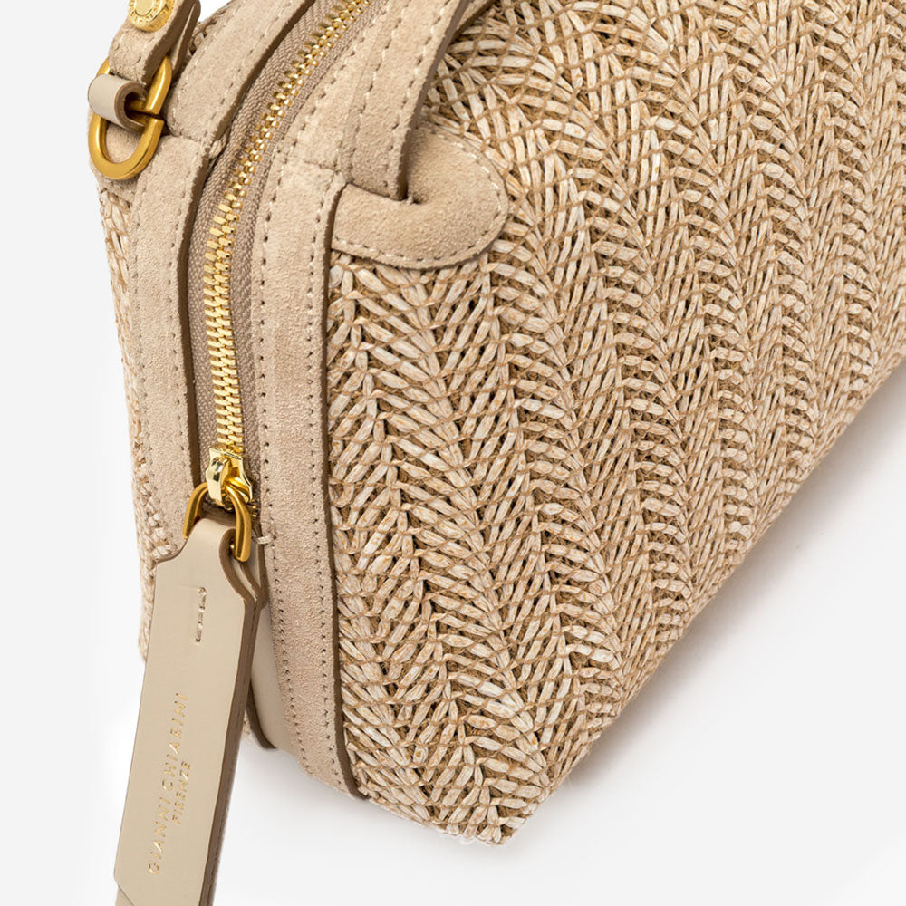 Woven handbag with a strap on a light grey background