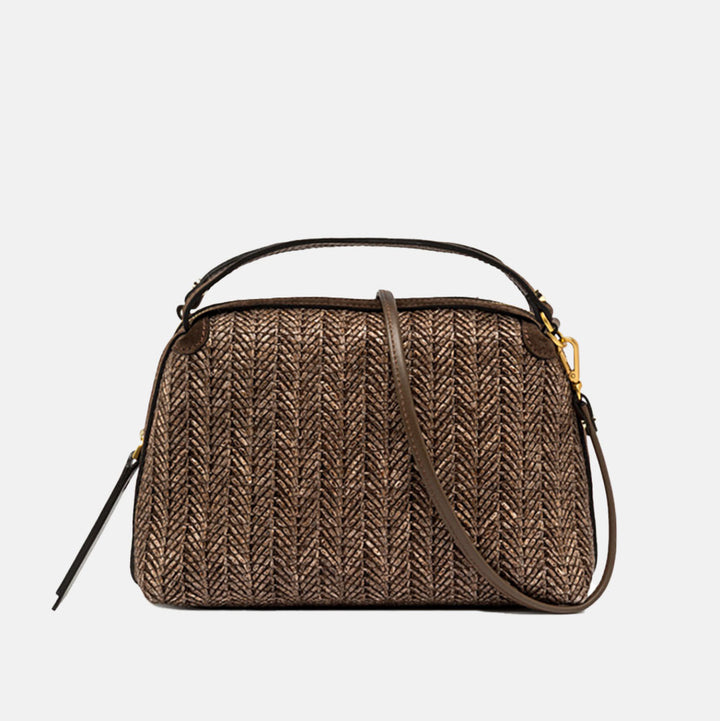 Dark brown woven straw handbag with a strap on a light grey background