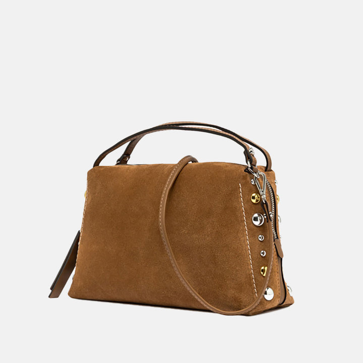 brown suede handbag with tonal grab handle and crossbody strap and studded with gold & silver studs