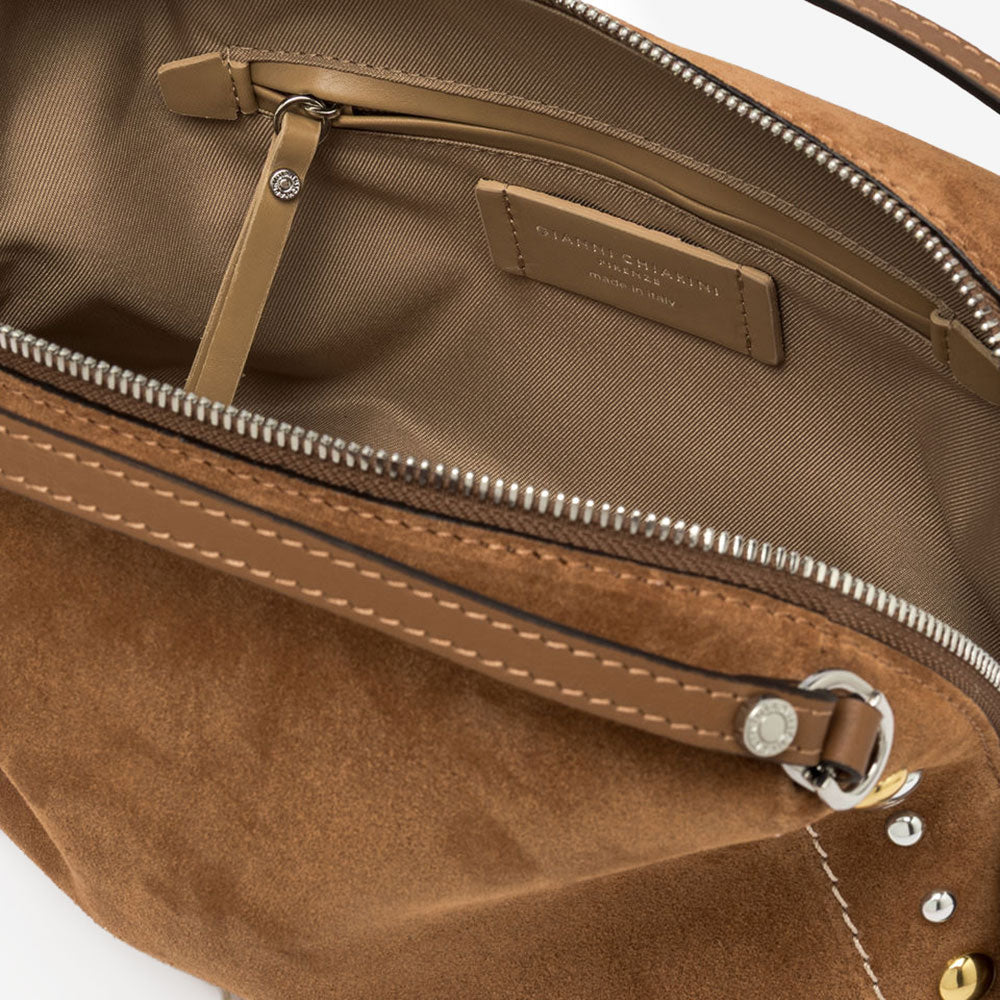 brown suede handbag with tonal grab handle and crossbody strap and studded with gold & silver studs