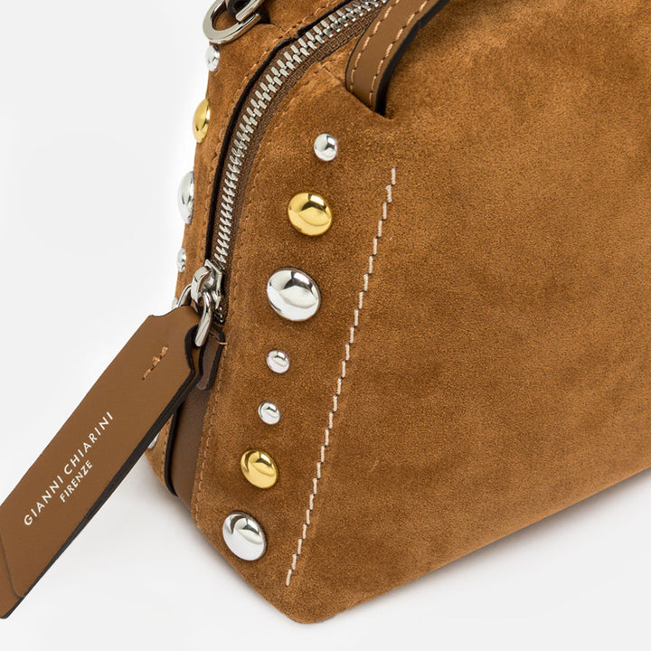 brown suede handbag with tonal grab handle and crossbody strap and studded with gold & silver studs