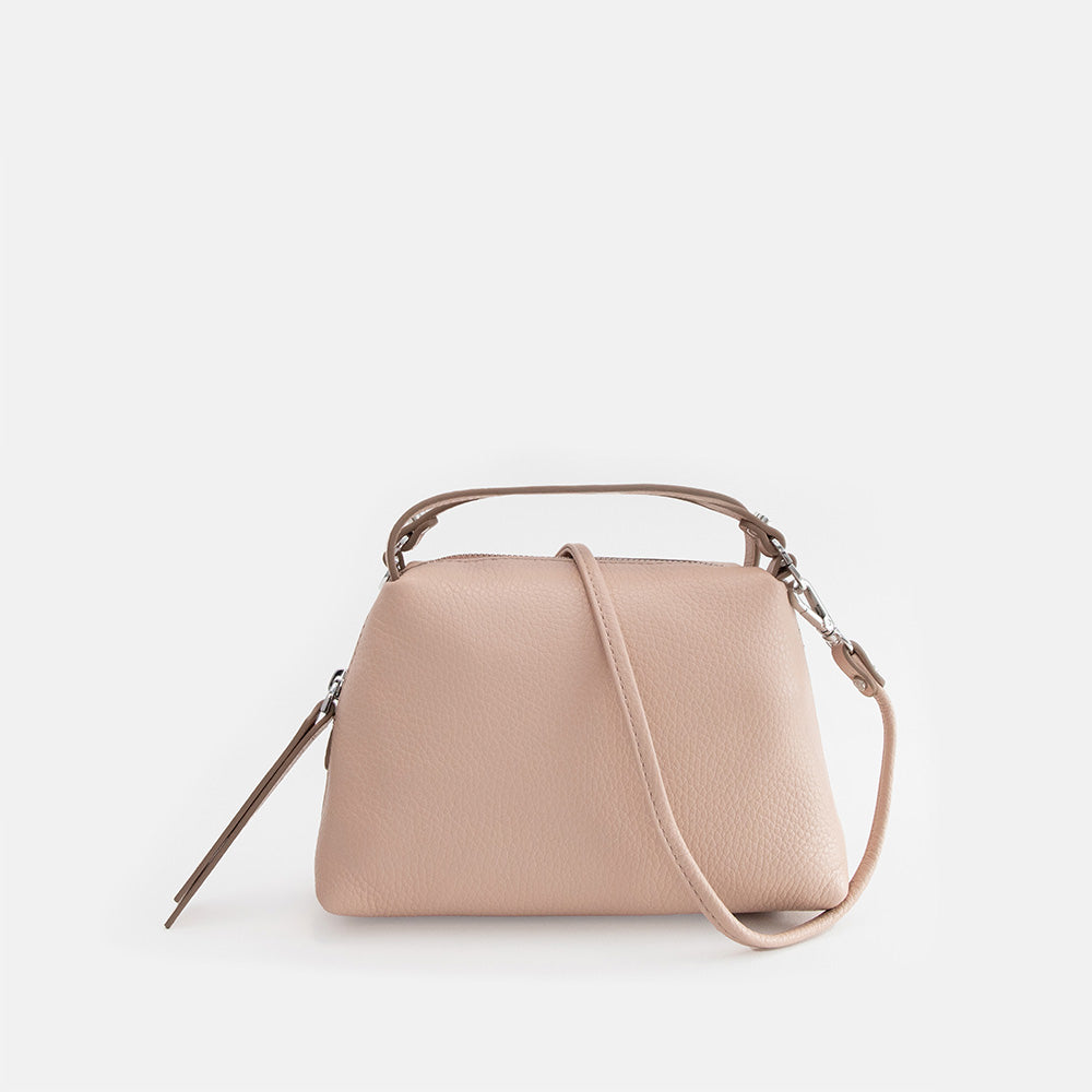 light pink leather handbag on a light grey background