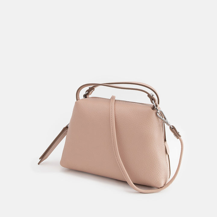 light pink leather handbag on a light grey background