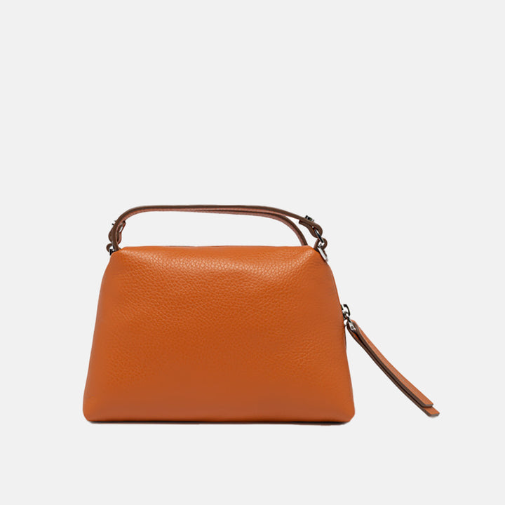 orange leather handbag on a light grey background