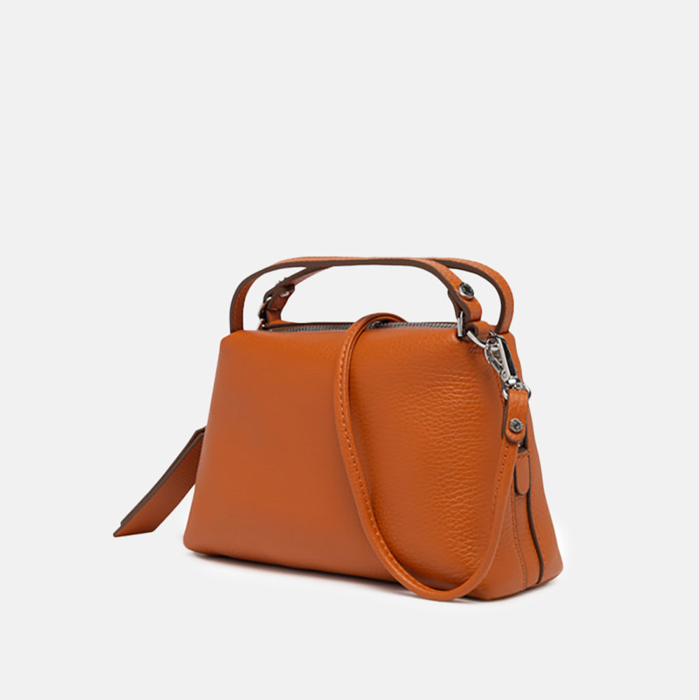 orange leather handbag on a light grey background