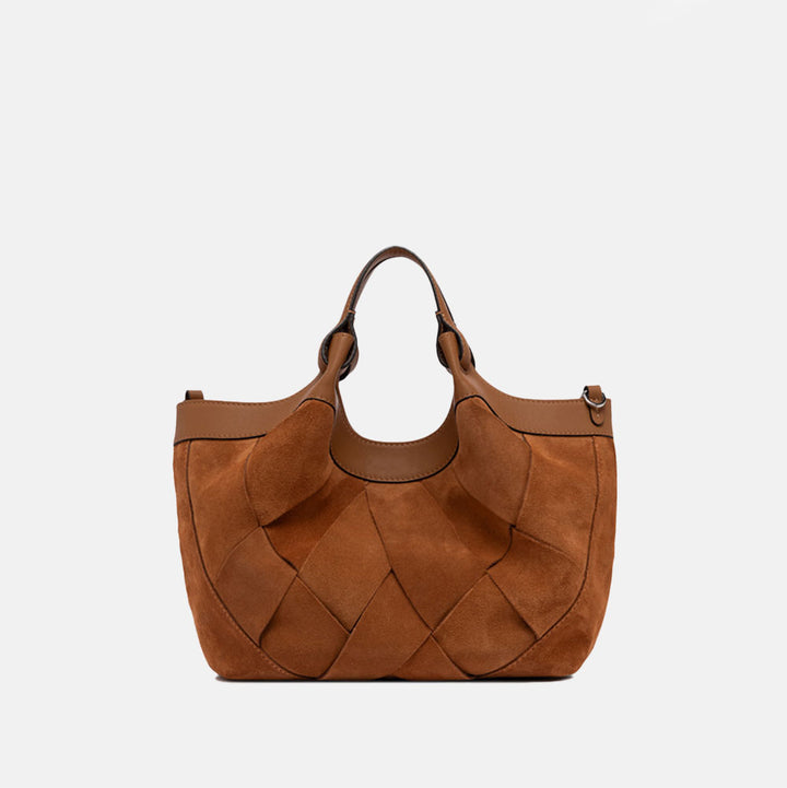 Brown woven chamois handbag with matching strap on a light grey background
