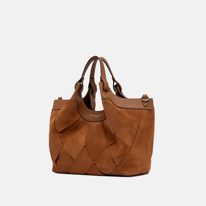Brown woven chamois handbag with matching strap on a light grey background