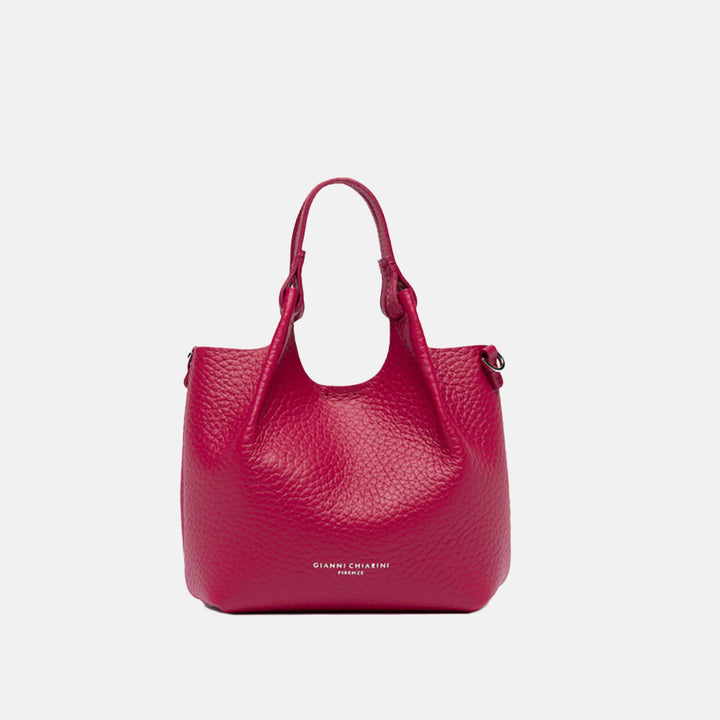 Pink handbag with matching strap on a white background