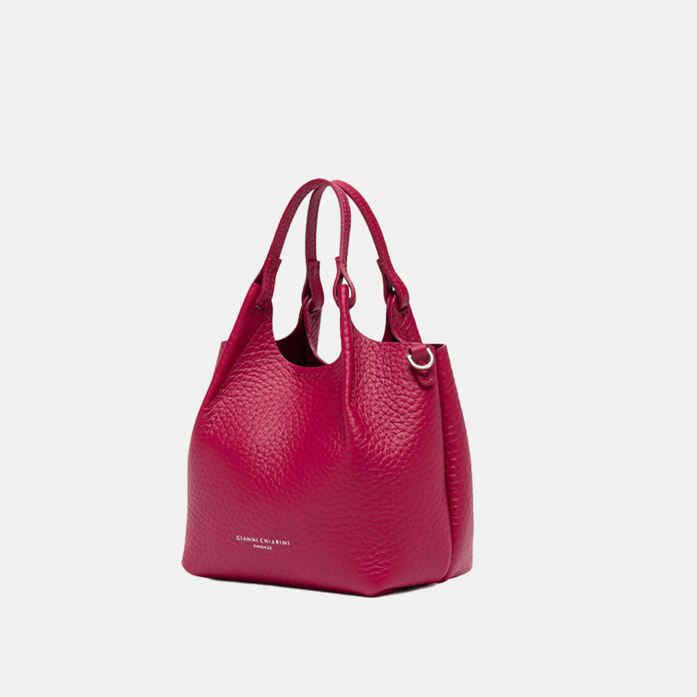 Pink handbag with matching strap on a white background