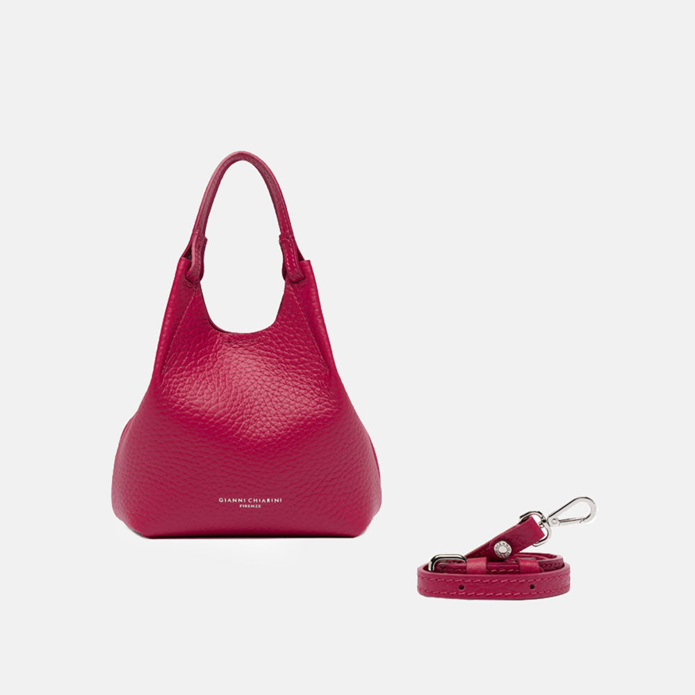 Pink handbag with matching strap on a white background