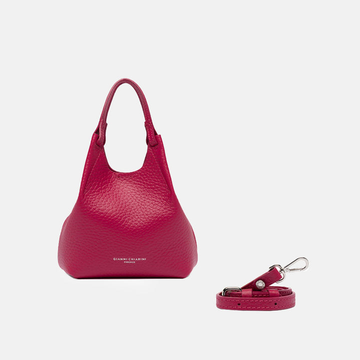 Pink handbag with matching strap on a white background