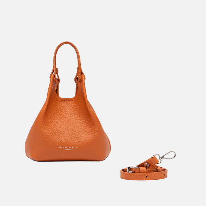 orange leather handbag on a light grey background