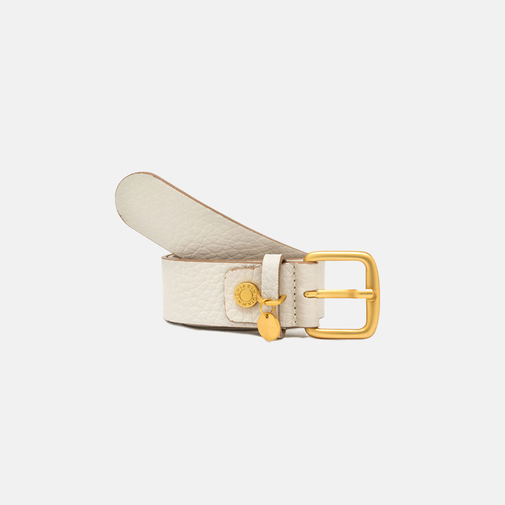 off white leather belt with gold buckle on a light grey background