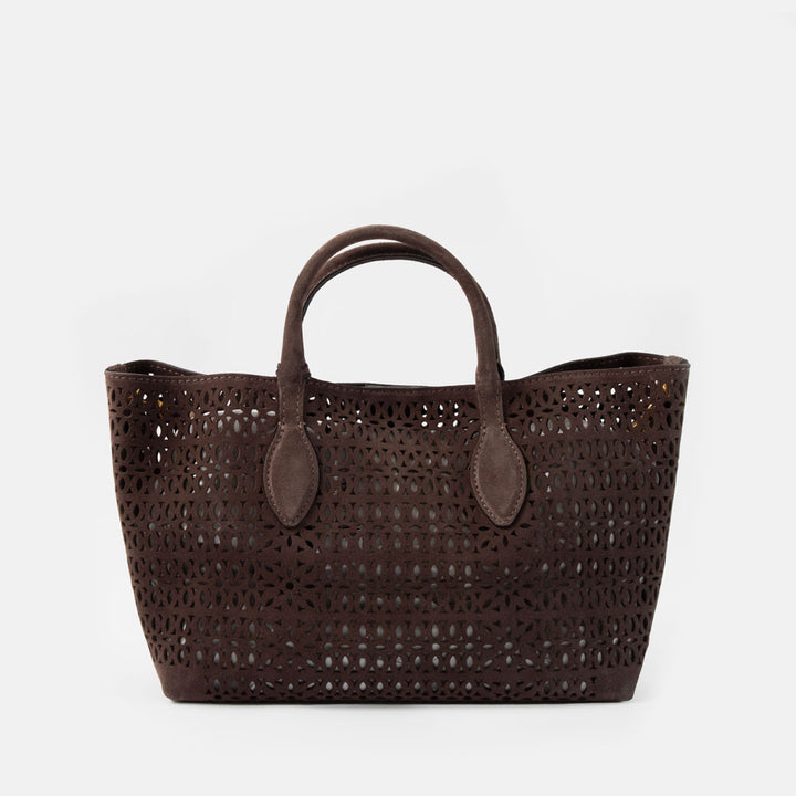 dark brown perforated suede handbag with brown leather grab handles on a white background
