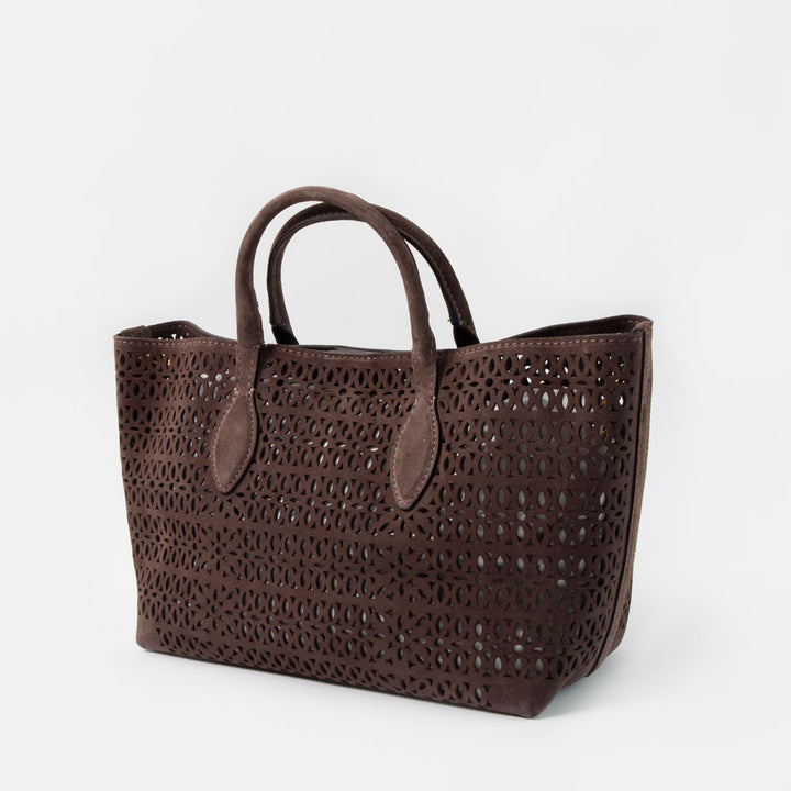 dark brown perforated suede handbag with brown leather grab handles on a white background