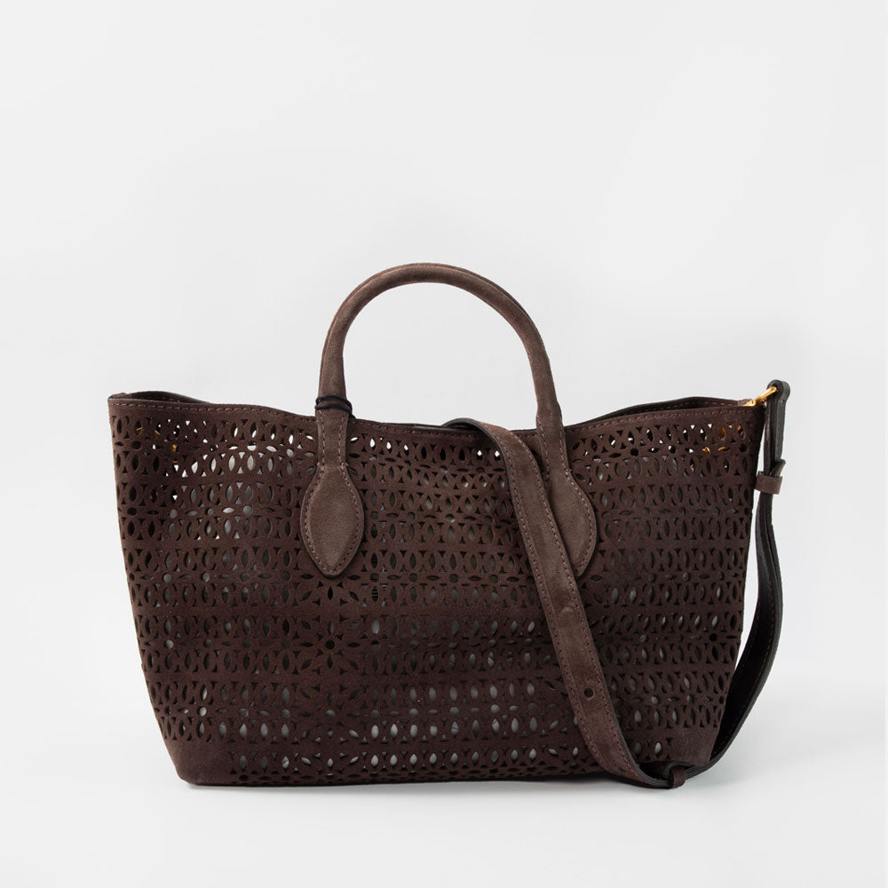 dark brown perforated suede handbag with brown leather grab handles and crossbody strap on a white background