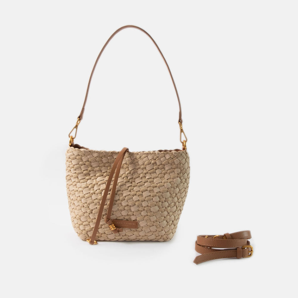 sand colour woven material handbag with light brown leather shoulder strap and crossbody strap on a white background