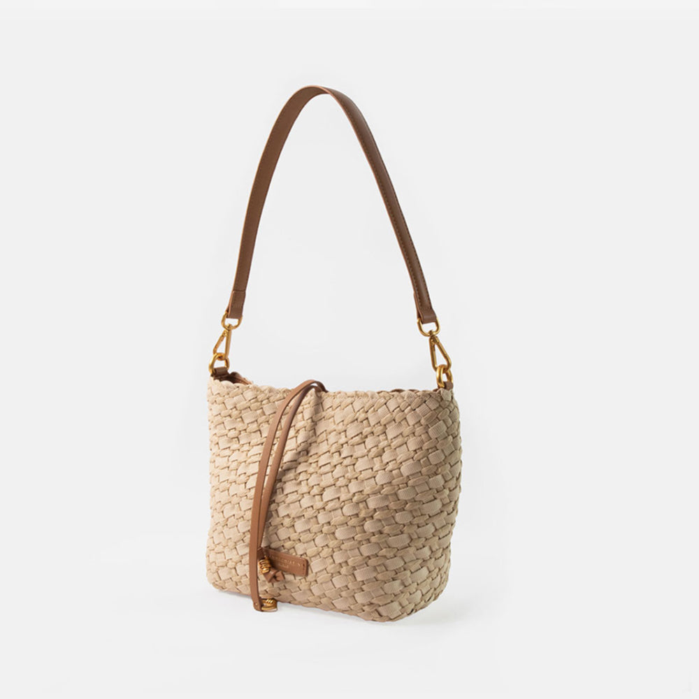 sand colour woven material handbag with light brown leather shoulder strap on a white background