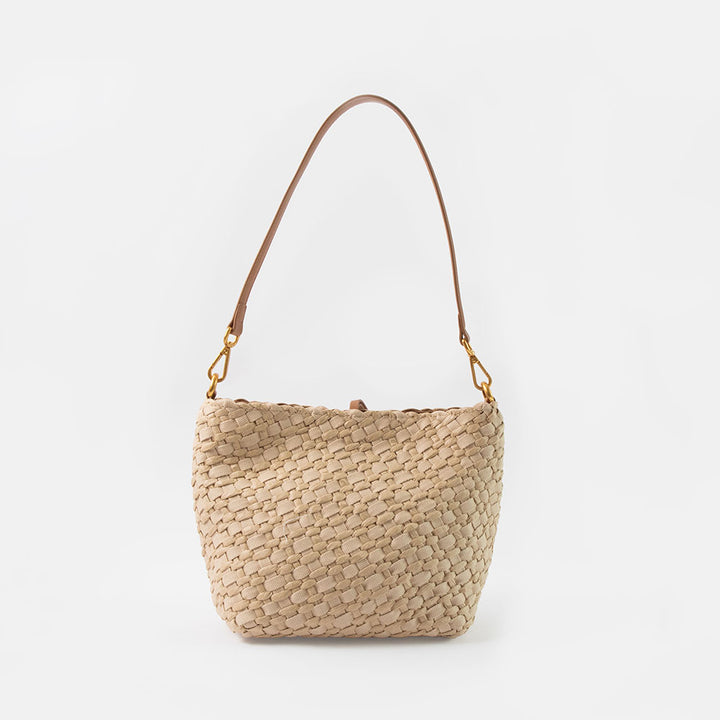 sand colour woven material handbag with light brown leather shoulder strap  on a white background