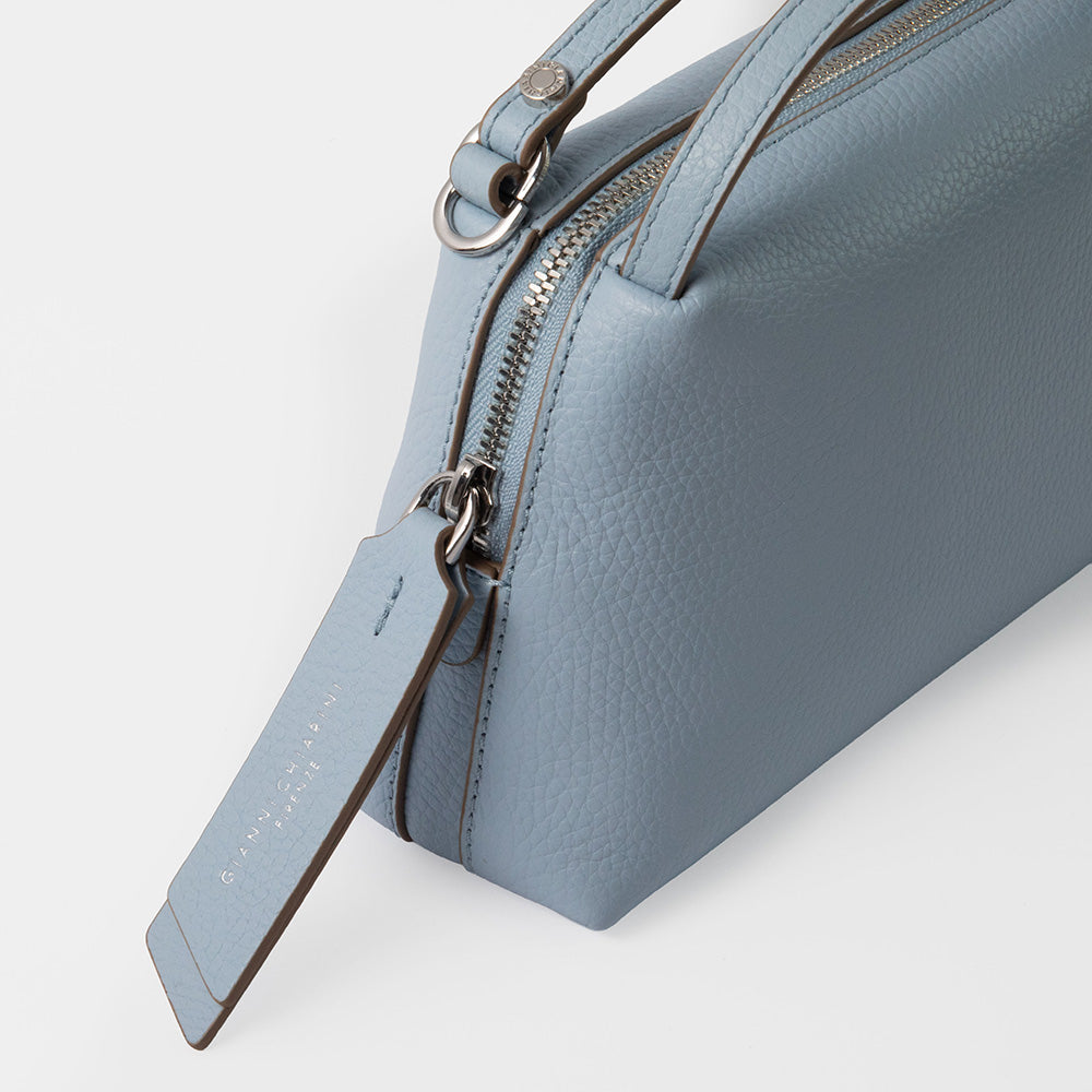 Light blue handbag with a visible brand name on a white background