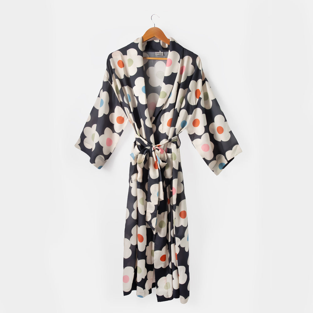 Floral patterned robe on a hanger against a white background