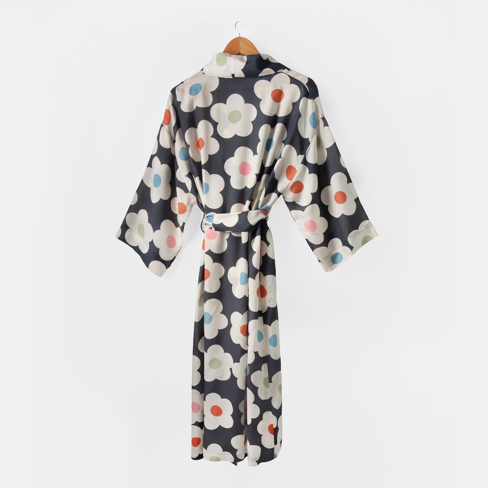 Floral patterned robe on a hanger against a white background