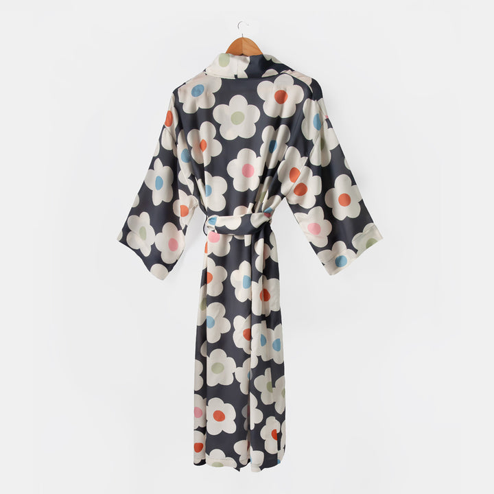 Floral patterned robe on a hanger against a white background