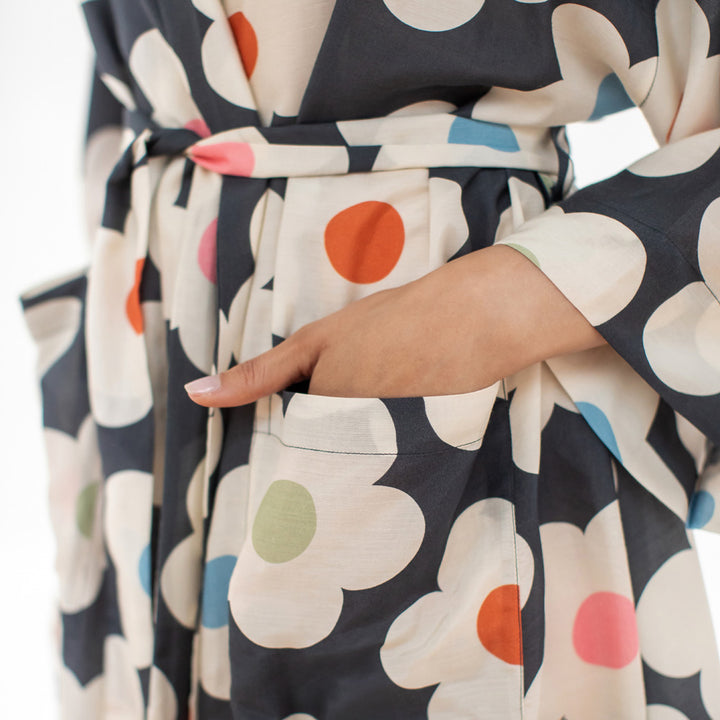 Close-up of a floral-patterned dressing gown with a hand in the pocket