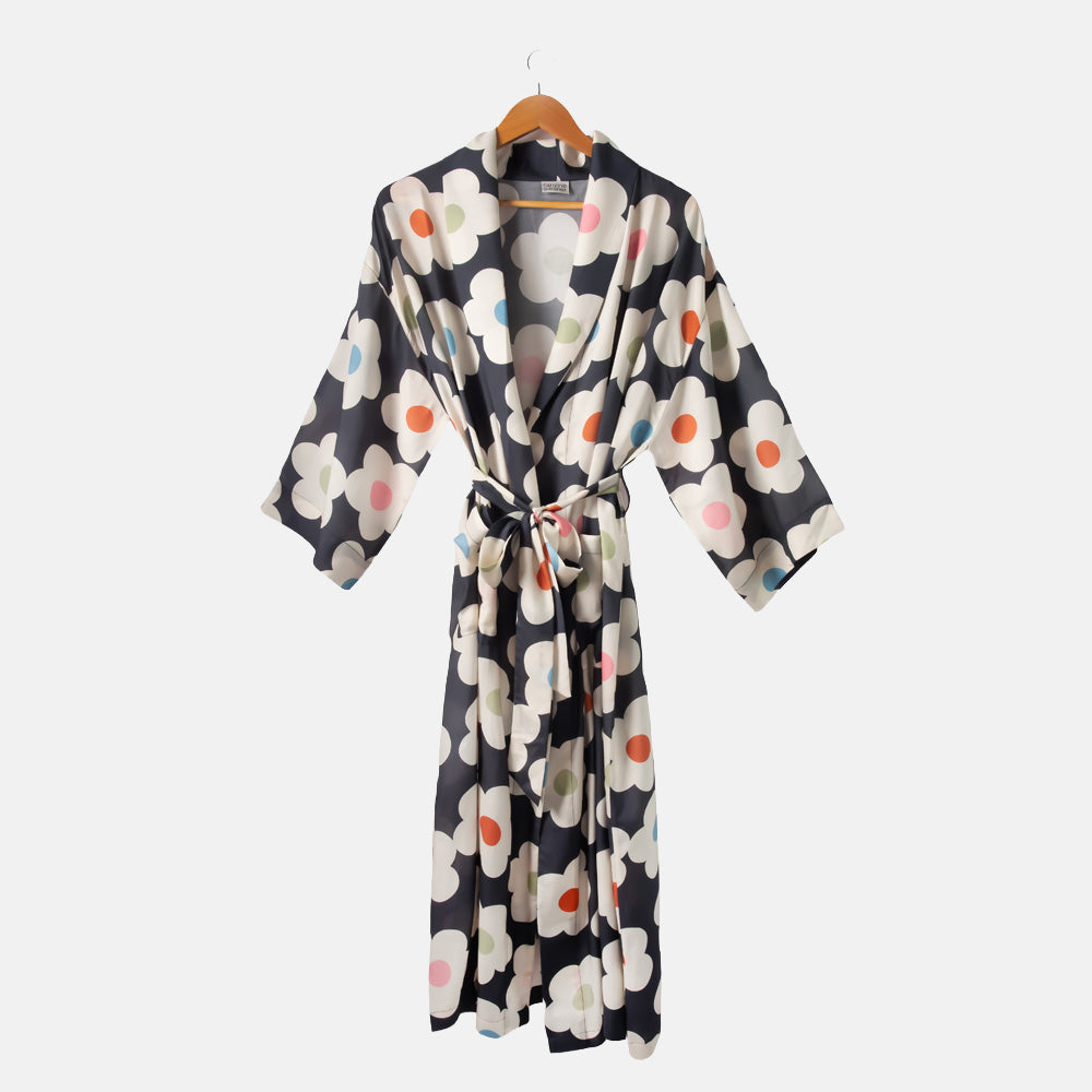 Floral patterned robe on a hanger against a white background