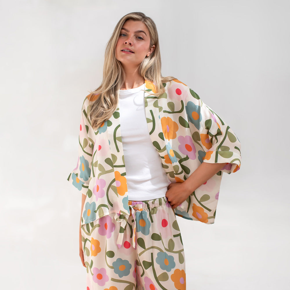 Woman wearing a floral outfit with a white background