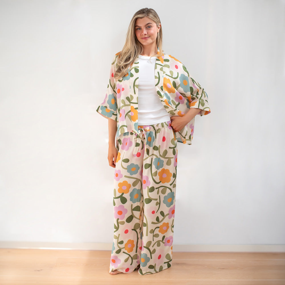 Woman wearing a floral outfit with a white background