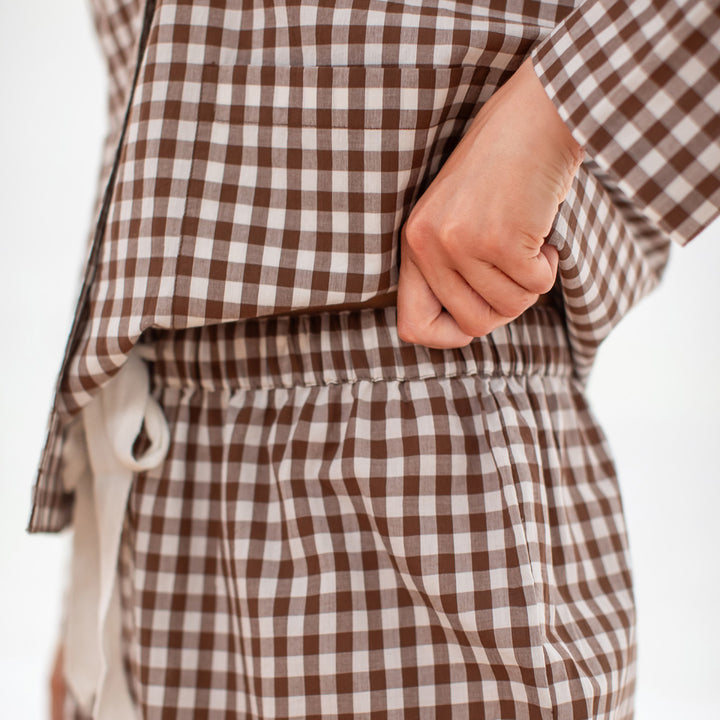 Brown and white checkered lounge pants with a white background