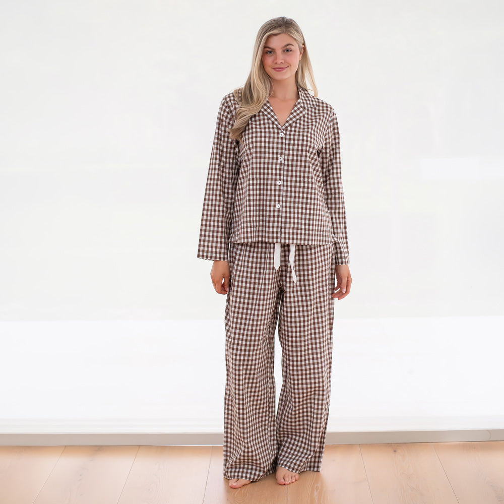 Woman wearing a checkered pajama set on a white background