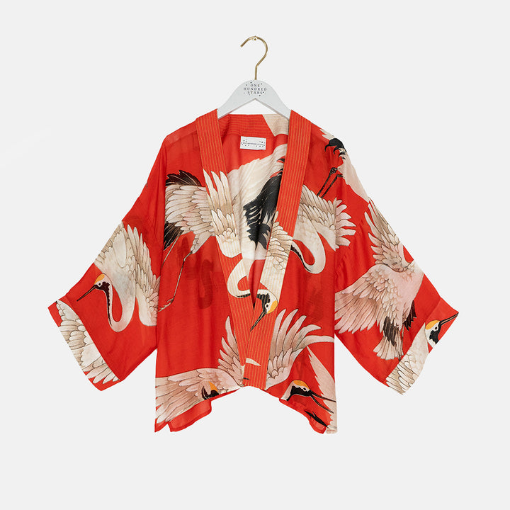 women's short kimono with white storks on a bright red base