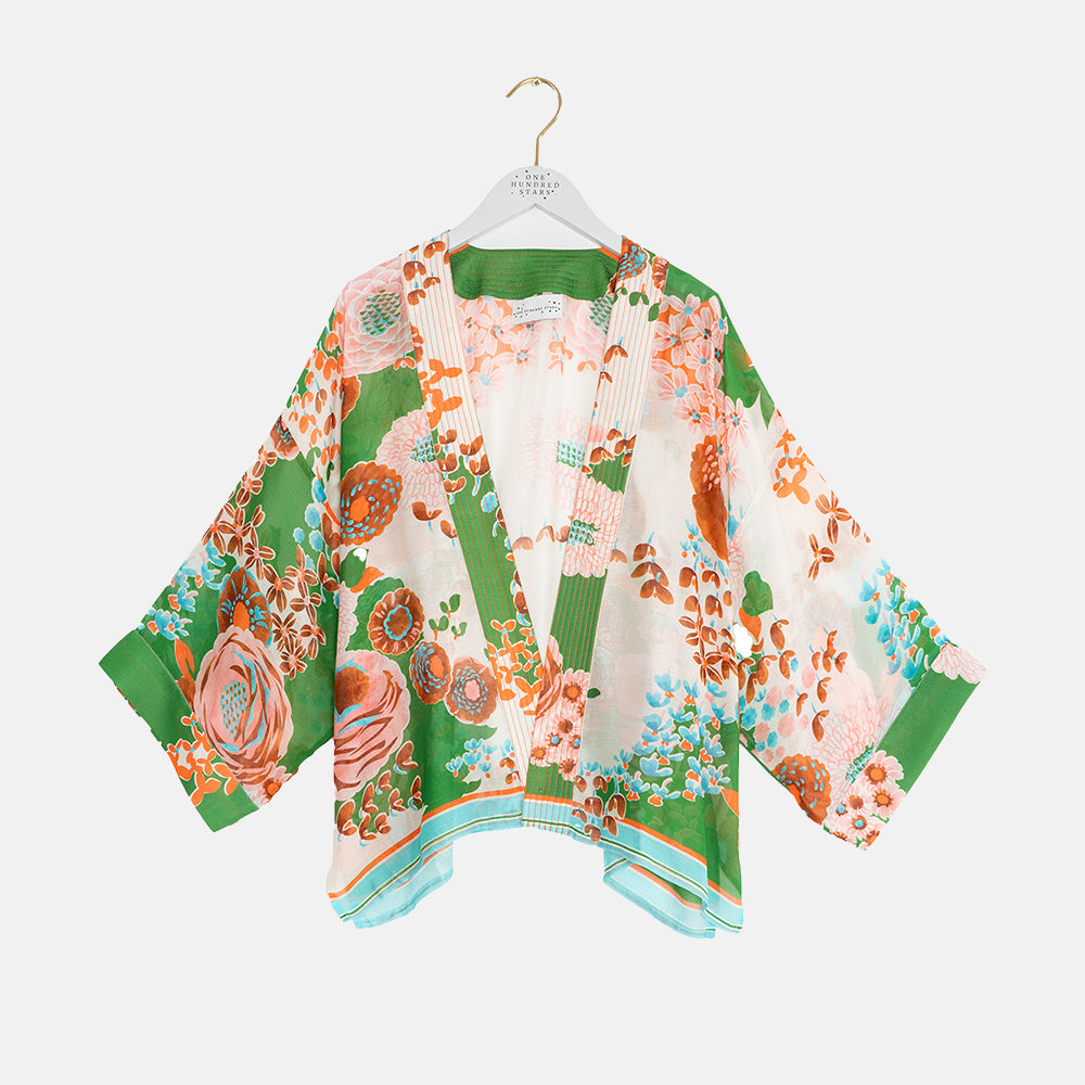 women's short kimono on orange and pink floral design on a green and stone base