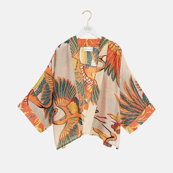 women's short kimono in orange, green & blue cranes print on a stone base