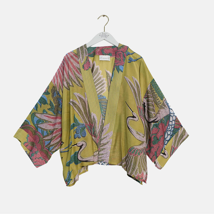women's short kimono with pink, green & blue cranes design on an olive base