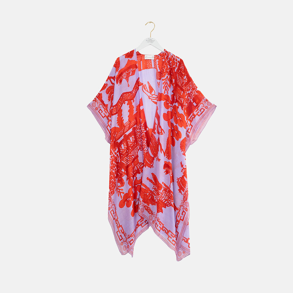 red Japanese willow on a lilac summer throwover on a light grey background