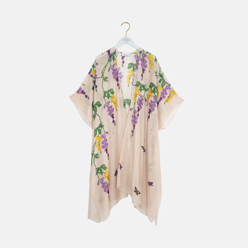 Floral throwover on a hanger against a white background