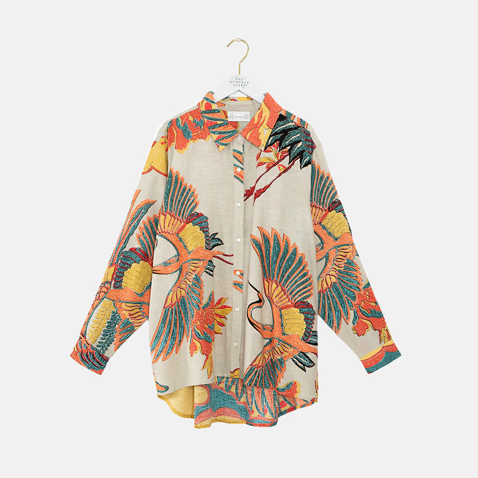 women's oversized long-line shirt in colourful crane print on a stone base