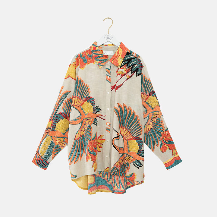 women's oversized long-line shirt in colourful crane print on a stone base