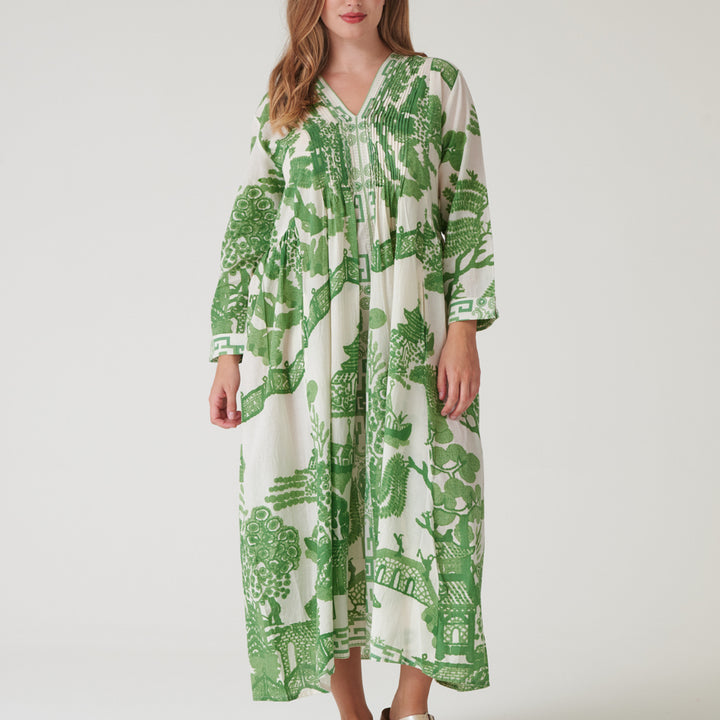 person wearing a green and white Japanese patterned dress on a hanger against a white background