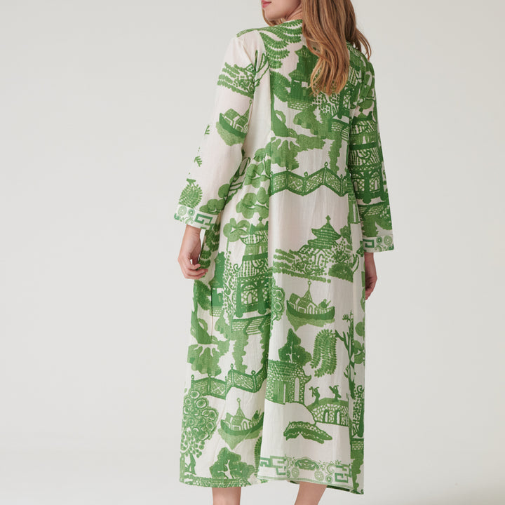person wearing a green and white Japanese patterned dress on a hanger against a white background