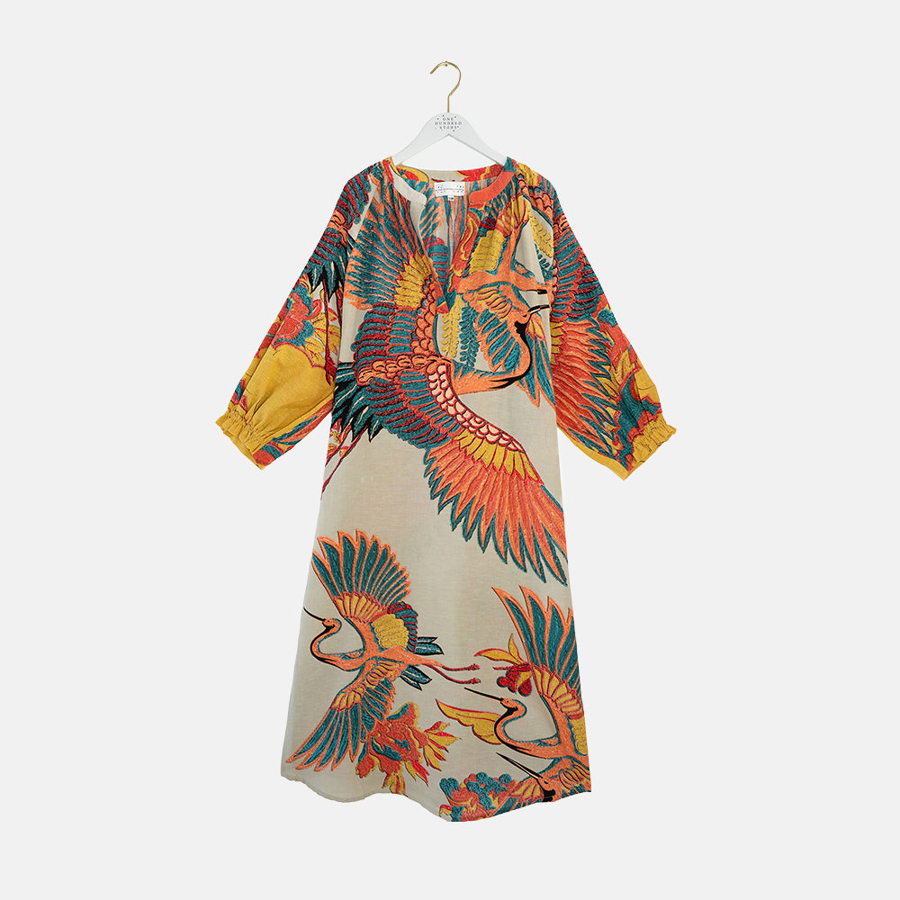Colourful dress with crane pattern on a white background